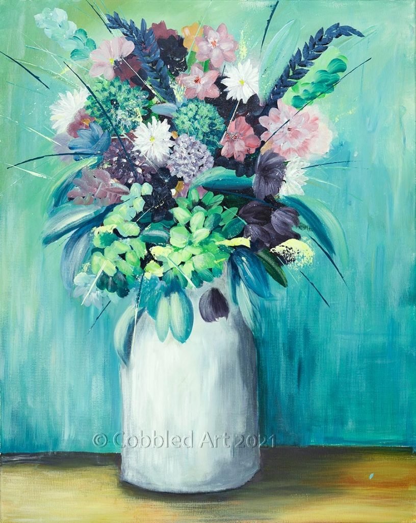 a white vase containg a bunch of colourful flowers